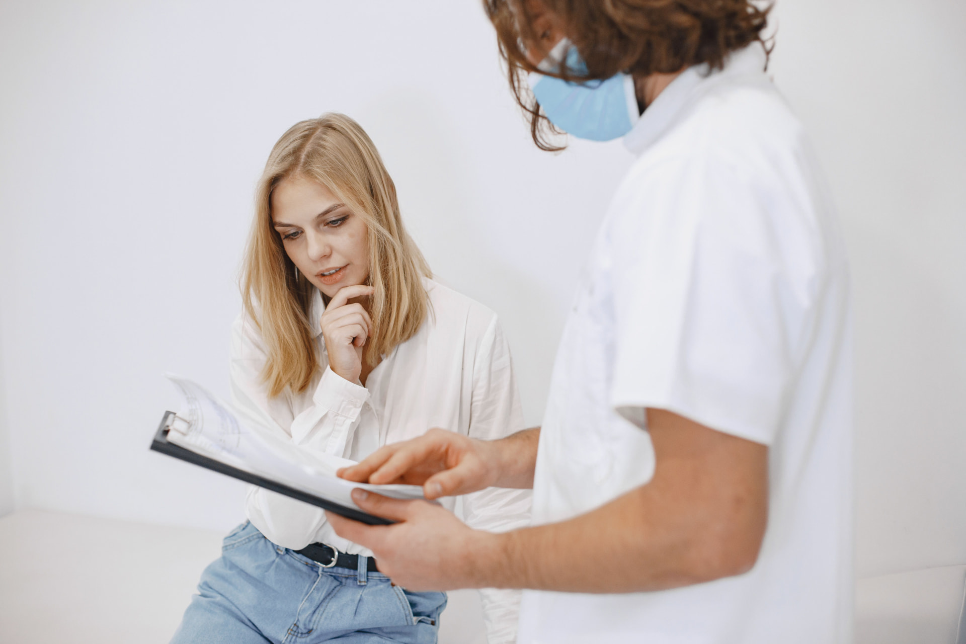 Clinician reviewing scalp analysis images with a client during consultation