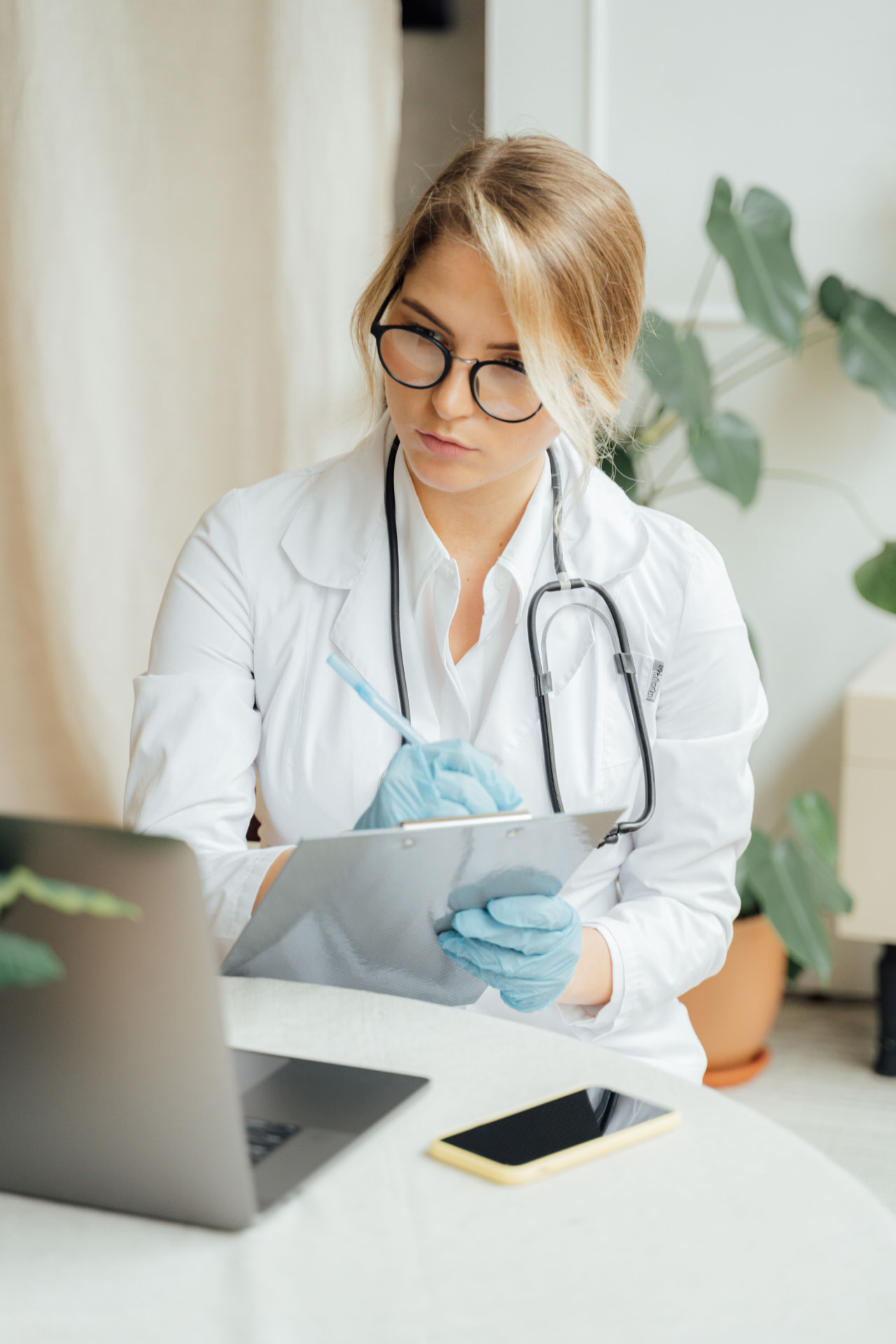 Practitioner writing a personalised hair treatment plan beside scalp analysis results